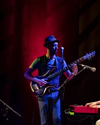 Bass guitarist blue hat