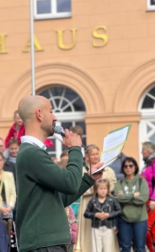 Man green sweater microphone